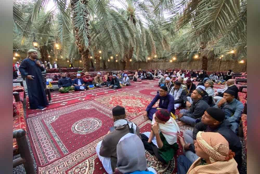 Nik Saiful Adli (berdiri) semasa sesi lawatan ke kebun kurma di Madinah.