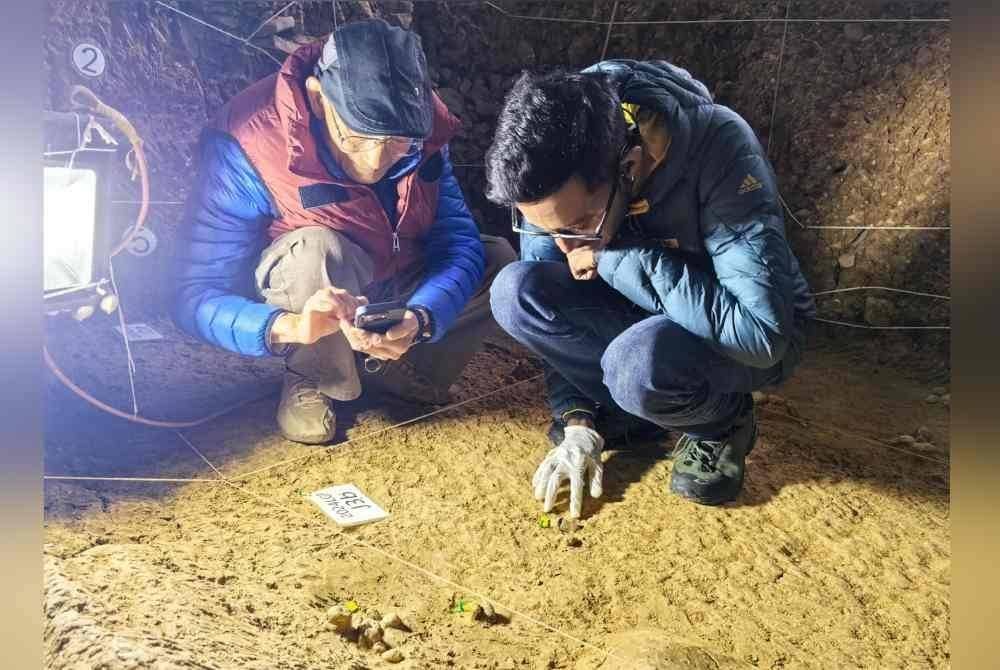 Dr Rummy bersama ahli paleontologi Dr Huang Wanpo, 93, memeriksa koprolit (fosil najis) berusia dua juta tahun di Longgupo, yang juga dikenali sebagai 'Dragon Bone Cave' di Wushan, China. Foto Bernama