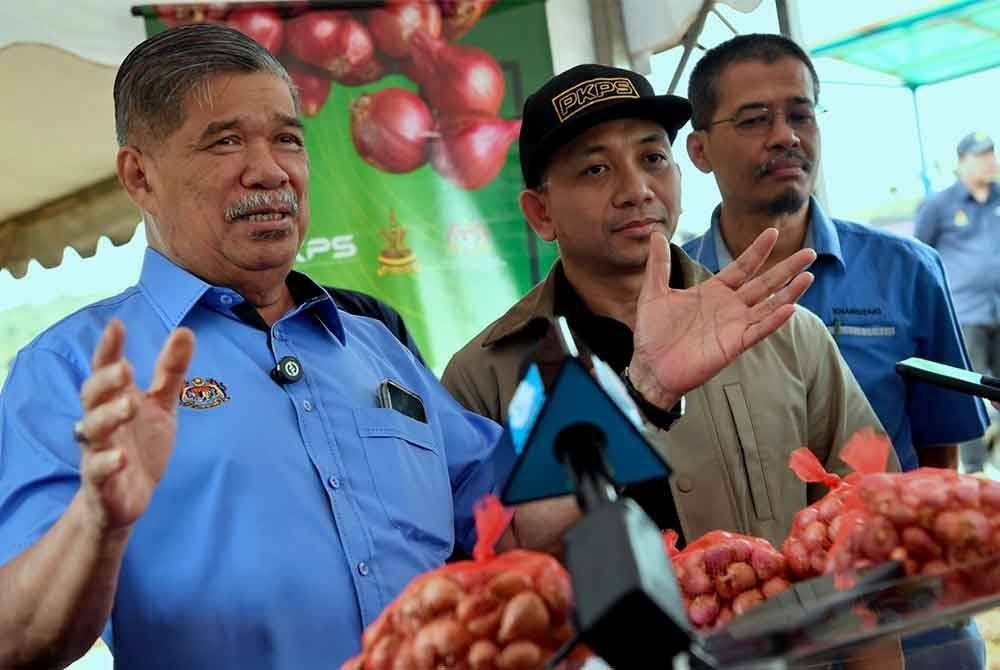 Menteri Pertanian dan Keterjaminan Makanan, Datuk Seri Mohamad Sabu (kiri) semasa sidang media selepas meninjau Projek Tanaman Bawang Rose Ehsan Perbadanan Kemajuan Pertanian Selangor (PKPS) di Selangor Fruit Valley (SFV) Bestari Jaya, Kuala Selangor pada Sabtu. Foto Bernama