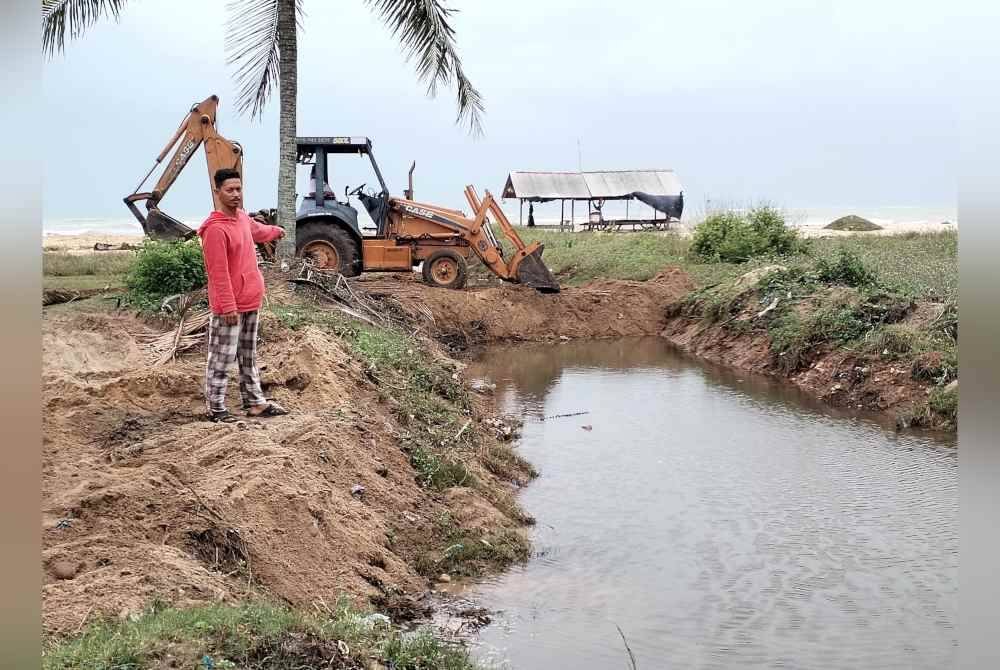 Zulkifli menunjukkan inisiatif penduduk menutup sistem perparitan bagi mengelak rumah mereka dimasuki air ekoran fenomena air pasang besar yang melanda sejak malam Sabtu.