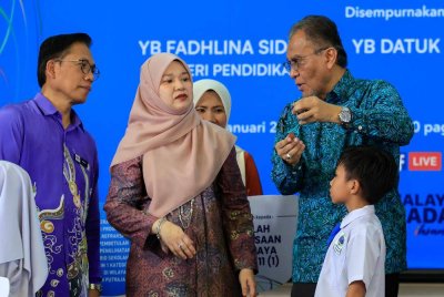 Dr Dzulkefly menunjukkan kaca mata yang diterima salah seorang murid kepada Fadhlina. Foto Bernama