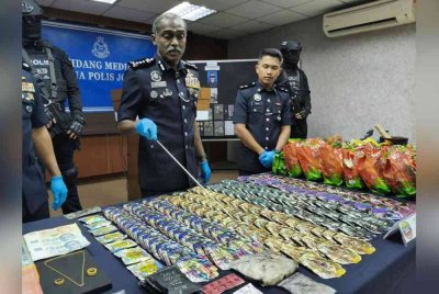 Kumar menunjukkan sebahagian dadah yang dirampas.