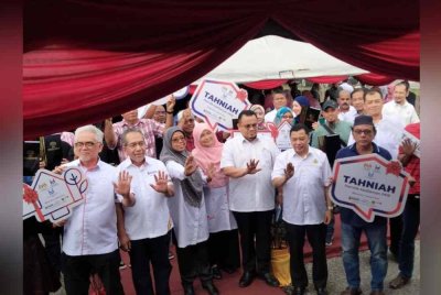 Aiman Athirah (tiga, kiri) bergambar bersama tetamu selepas menyempurnakan Majlis Penyerahan Surat Tawaran bagi Program Perumahan Rakyat (PPR) Gual Ipoh, Tanah Merah pada Isnin.