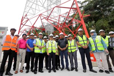 Fahmi bergambar berlatarbelakangkan menara perkongsian 6-Way MOCN KJS-UM selepas Majlis Pelancaran Garis Panduan Perkongsian Rangkaian dan Infrastruktur Telekomunikasi di Replika Tengkolok Gergasi pada Isnin. Foto Bernama