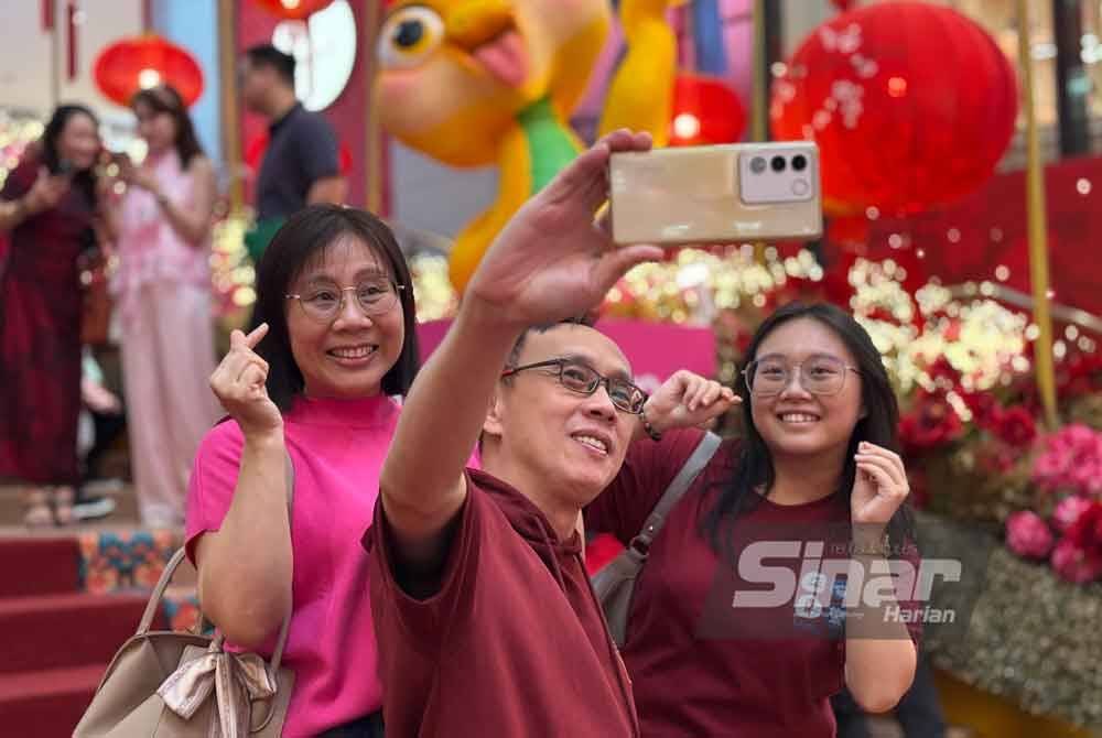 Chan Yiyi bersama ibu bapanya yang menyambut Tahun Baharu Cina di Bukit Bintang pada Rabu.