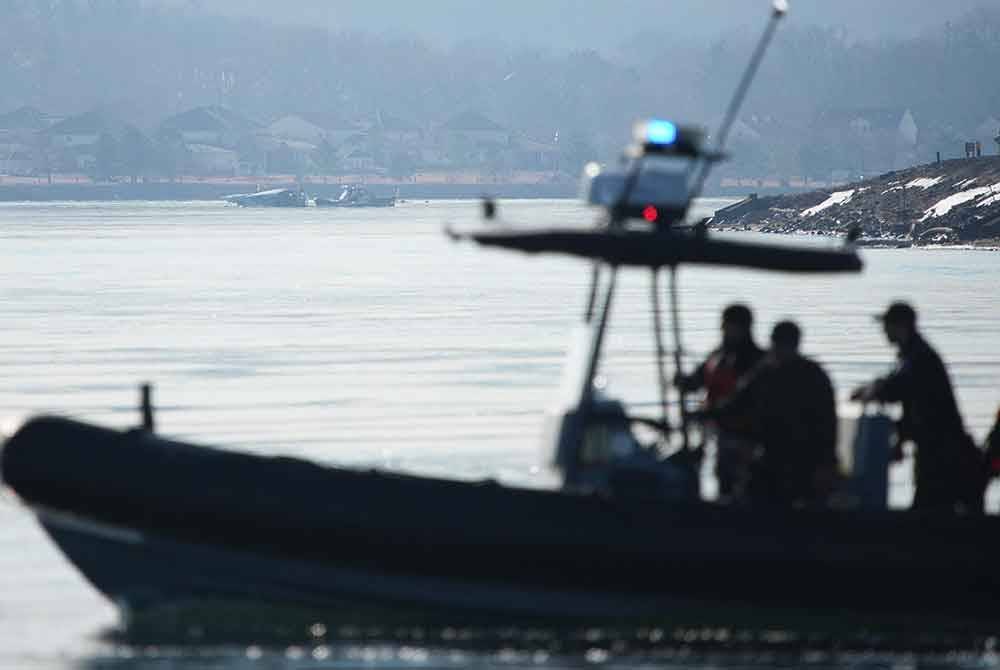 Unit tindak balas kecemasan mencari lokasi nahas pesawat American Airlines di Sungai Potomac selepas kemalangan malam tadi ketika dalam perjalanan ke Lapangan Terbang Nasional Reagan di Arlington, Virginia. Foto AFP