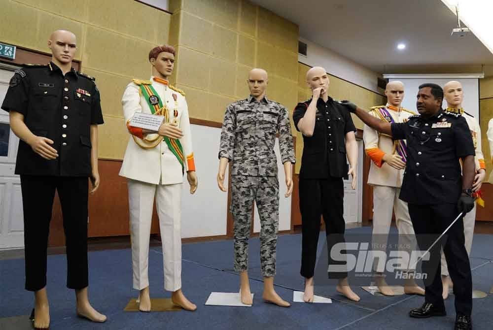 Hussein menunjukkan pakaian yang dirampas polis untuk siasatan kes membabitkan sebuah pertubuhan kebajikan. Foto: ROSLI TALIB