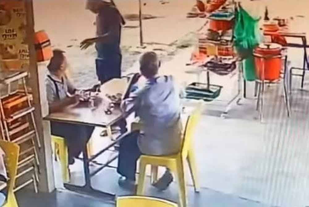 Tangkap layar video tular memaparkan seorang lelaki disamun individu berparang dalam kejadian di sebuah gerai di Morib pada Jumaat.
