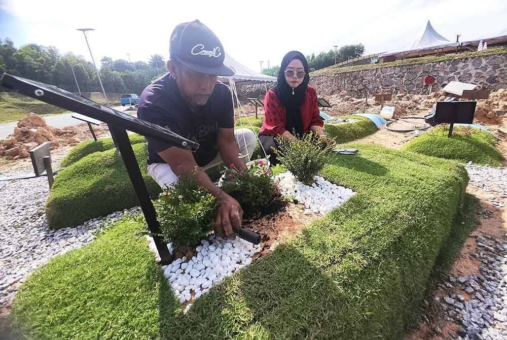 Menjadi rutin Marinah (kanan) dan Nor Hisham menziarahi pusara arwah pasangan masing-masing.