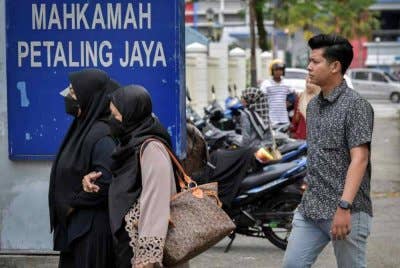 Ibu bapa Zayn Rayyan Abdul Matin, Zaim Ikhwan Zahari (kanan) bersama Ismanira Abdul Manaf (kiri) ketika tiba di Mahkamah Petaling Jaya pada Selasa.