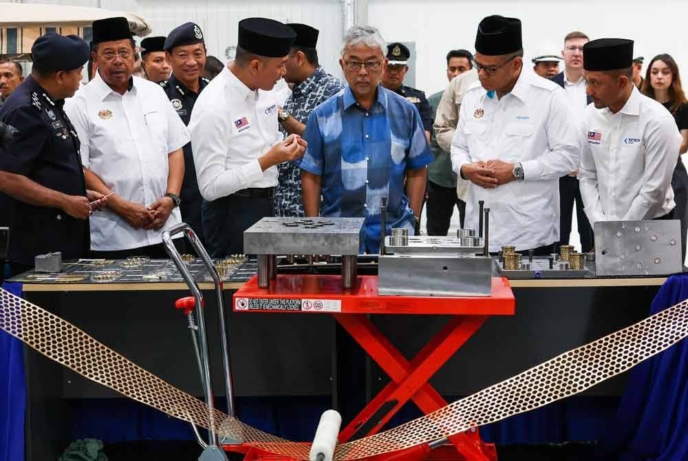 Sultan Pahang Al-Sultan Abdullah Ri'ayatuddin Al-Mustafa Billah Shah berkenan mendengar penerangan daripada Pengurus Besar Operasi Ketech Asia, A.M Maharis Abdul Wahab (empat dari kiri) ketika mencemar duli melawat Kilang Peluru Ketech Asia di sini, pada Khamis.
Turut kelihatan, Menteri Dalam Negeri Datuk Seri Saifuddin Nasution Ismail (dua, kanan) dan Ketua Pegawai Eksekutif Ketech Asia, Mohd. Nahar Nasir (kanan). Foto Bernama