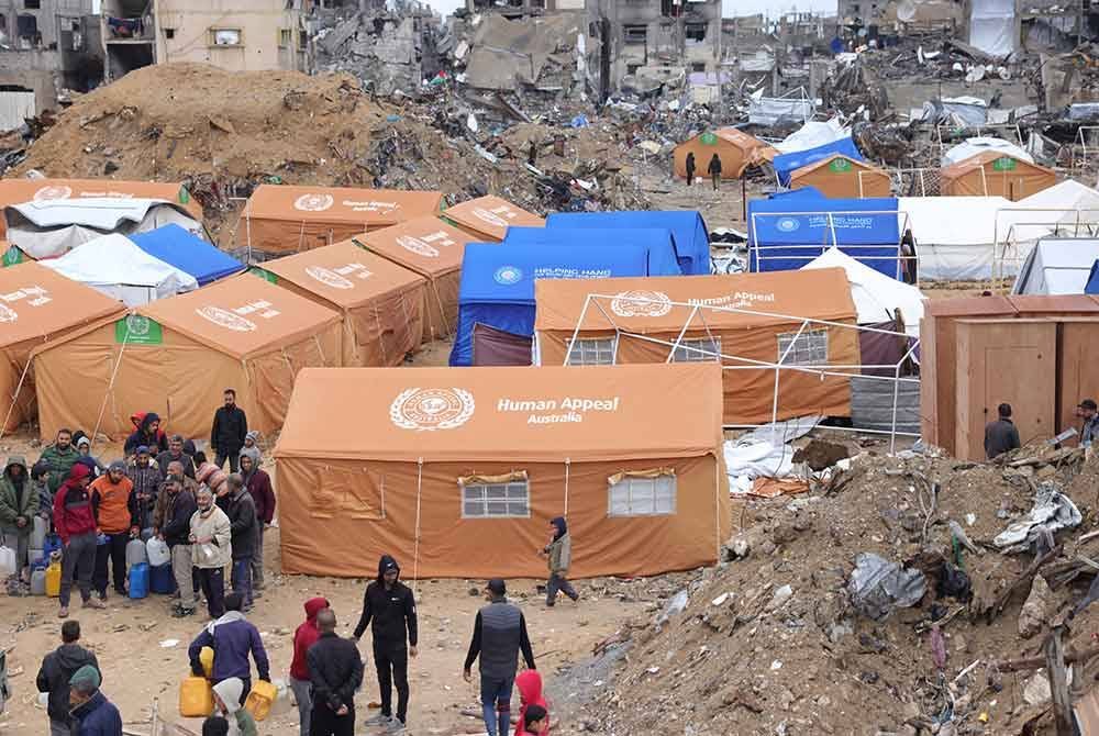 Penduduk Palestin berteduh di khemah yang didirikan di tengah-tengah bangunan yang rosak di Gaza.