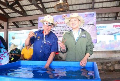 Mohamad (kiri) dan Arthur (kanan) menyempurnakan acara simbolik restorasi anak karang.