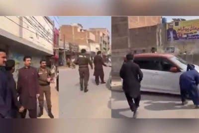 Beberapa pegawai tempatan dilihat menggunakan objek tajam untuk menebuk tayar kenderaan yang diparkir di sepanjang jalan. - Agensi