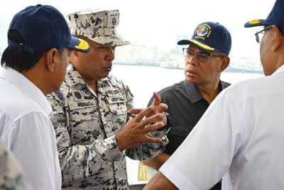 Saifuddin (dua dari kanan) diberi taklimat mengenai aset Maritim Malaysia ketika membuat lawatan pada Sambutan Dua Dekad Maritim Malaysia di Persiaran Karpal Singh, George Town pada Sabtu.