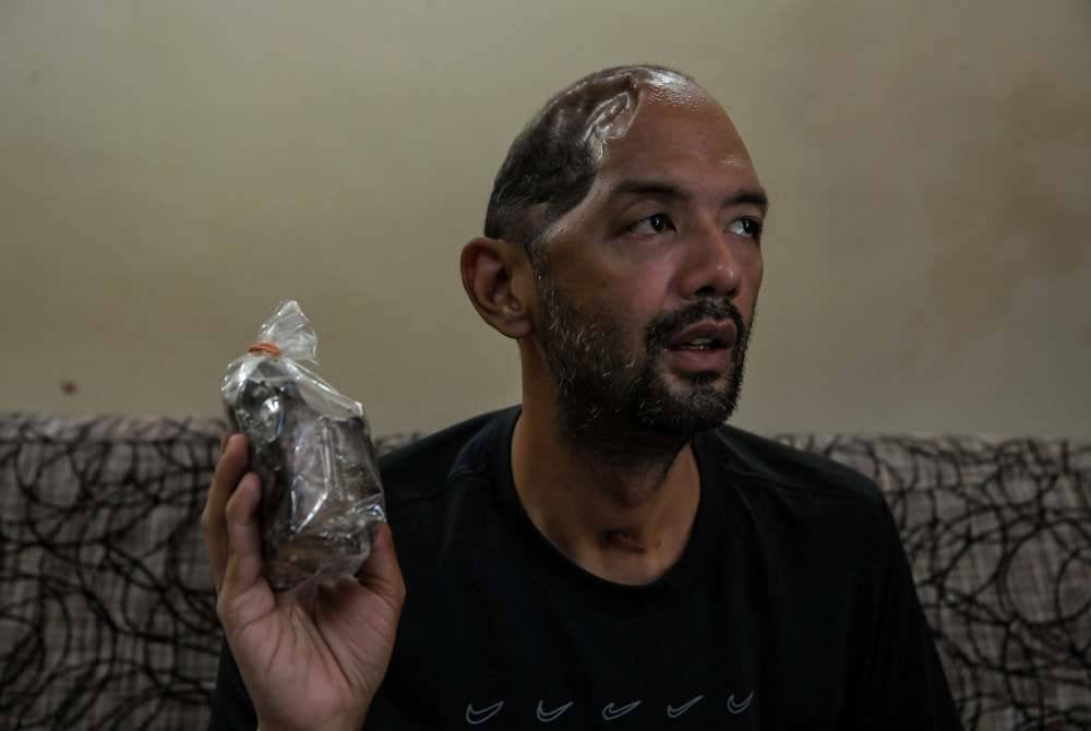 Muhammad Sufi Abdul Aziz,36 menunjukkan sebahagian daging salai yang sudah siap disalai. Foto Bernama