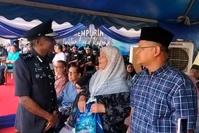 M Kumar (kiri) bertanya khabar kepada waris pada Majlis Memperingati Peristiwa Bukit Kepong di Galeri Darurat Bukit Kepong, Muar pada Ahad.