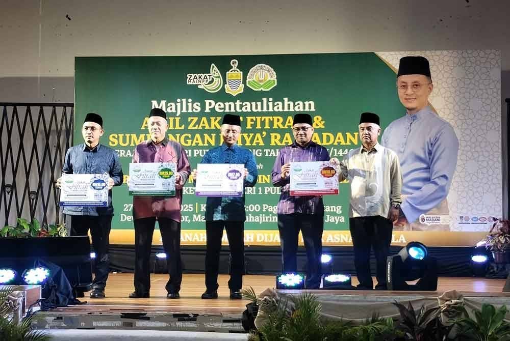 Mohamad (tengah) bersama wakil Zakat MAINPP menunjukkan empat kadar zakat fitrah Pulau Pinang untuk 2025.