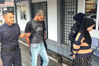 Nurul Ain dan Ermer Irfan diiring polis ketika hadir ke Mahkamah Majistret Port Dickson pada Khamis.