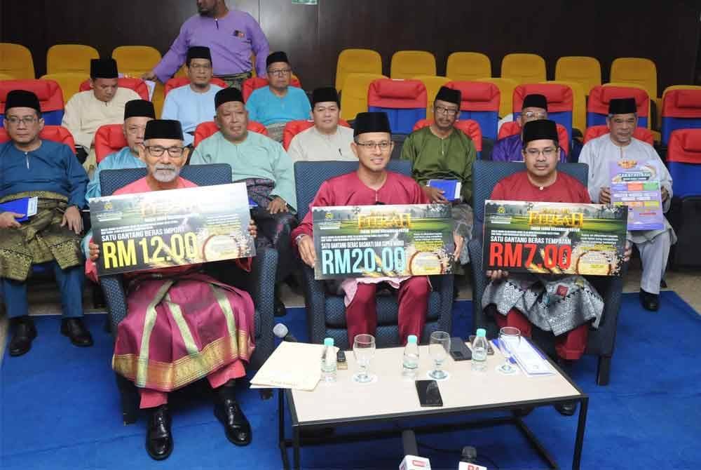 Mohd Fared (tengah) bersama Nooh Gadot (kiri) dan Hasrin Kamal menunjukkan kadar zakat fitrah Negeri Johor 1446H/2025M sempena Pelancaran Sambutan 100 Tahun Majlis Agama Islam Negeri Johor dan Pengumuman Kadar Zakat Fitrah di Pusat Islam Iskandar di sini.