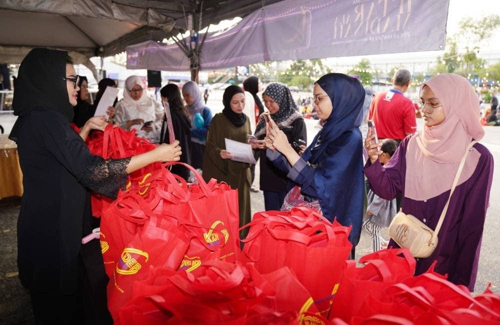 Pekerja KDEBWM memberikan sumbangan goodies kepada pengunjung