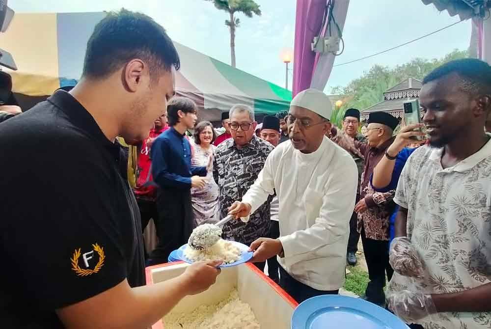Zambry menuangkan nasi kepada salah seorang mahasiswa USM yang mengambil bahagian dalam Program Kembara Ramadan KPT, di sini pada Ahad.