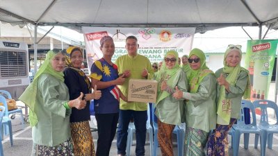 Pengarah Hal Ehwal Luar Mahsuri Dagang, Mohd Jazri Ikmal Hijaz (tengah) menyaksikan pemberian sumbangan bubur lambuk daripada Mashita (dua dari kanan) kepada wakil masjid dalam Program Rewang Bubur Lambuk Perdana 2025 pada Ahad.