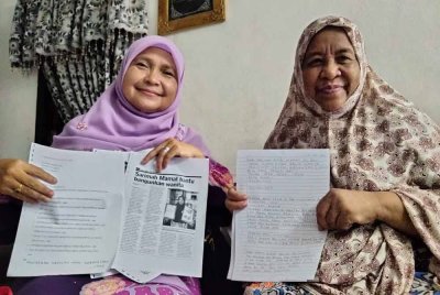 Sarimah (kanan) menunjukkan surat yang ditulis kepada Mohd Na'im.