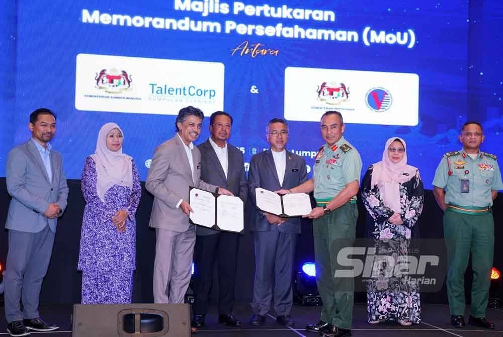 Adly (tiga dari kanan) dan Abdul Rahman (tiga dari kiri) menyaksikan pertukaran dokumen perjanjian antara Talent Corporation Malaysia Berhad (TalentCorp) dan Jabatan Hal Ehwal Veteran (JHEV) pada Sesi Libat Urus dan Bengkel Strategik Vateran MyWira di sebuah hotel di sini pada Isnin. FOTO SINAR HARIAN/MOHD HALIM ABDUL WAHID