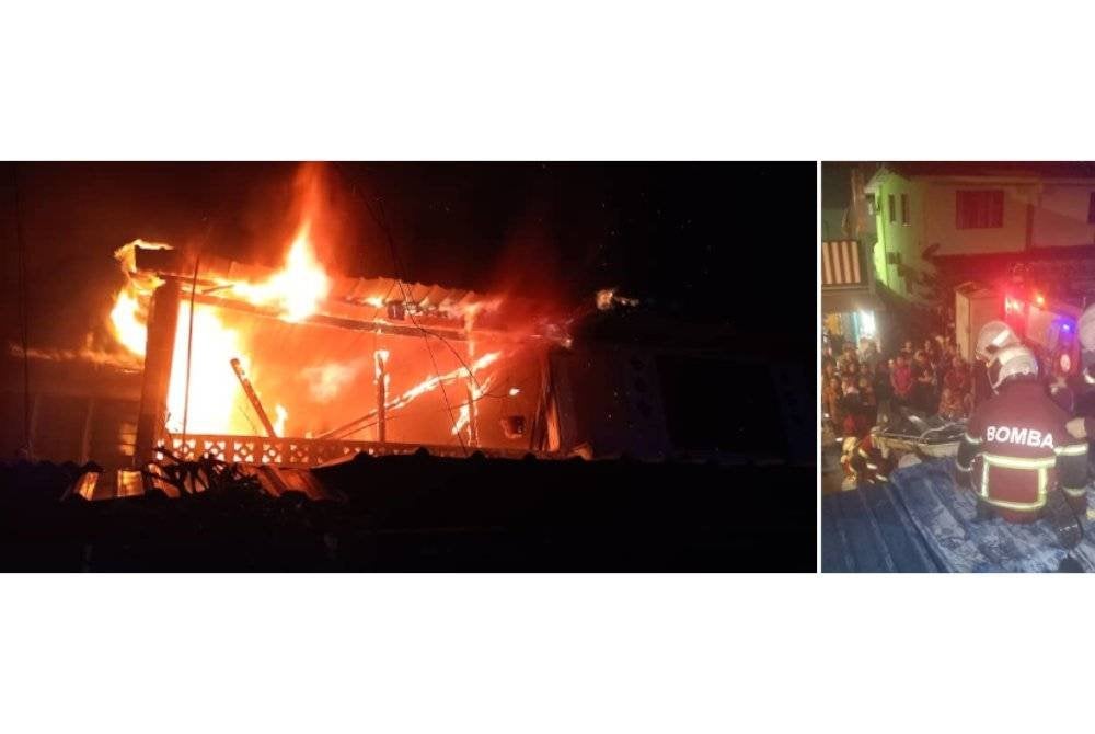 Anggota bomba menurunkan mangsa dari tingkat atas salah sebuah rumah teres yang terbakar di Taman Permas Jaya, awal pagi Sabtu. Foto JBPM Johor