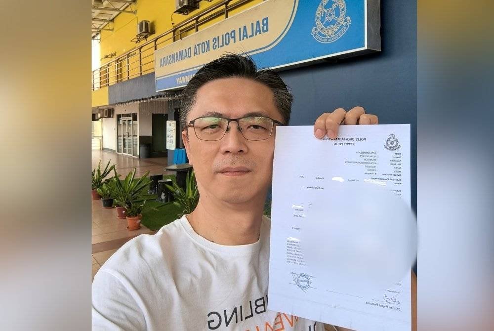 Hoe Ng menunjukkan laporan polis yang dibuat olehnya.