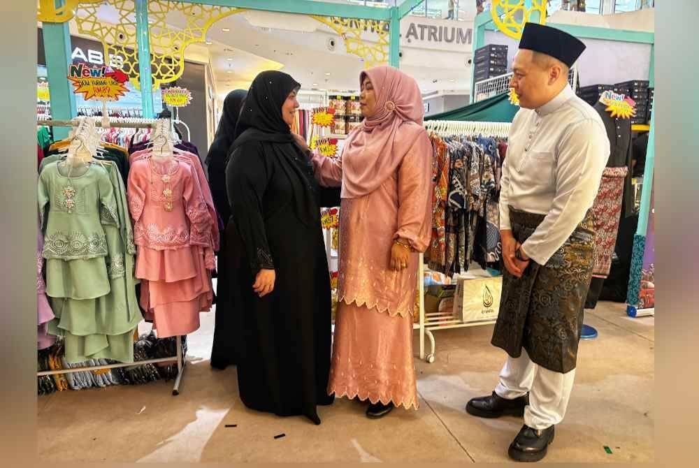 Halimaton Shaadiah (dua dari kanan) beramah mesra dengan pengunjung Aman Central sambil diperhatikan oleh Ken Chin.