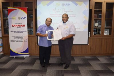 Mohd Fo’ad (kanan) menyerahkan surat pelantikan Profesor Adjung kepada Ramli dalam Majlis Kerjasama Penyelidikan bersama UUM di Ibu Pejabat KDEB Waste Management pada Jumaat.