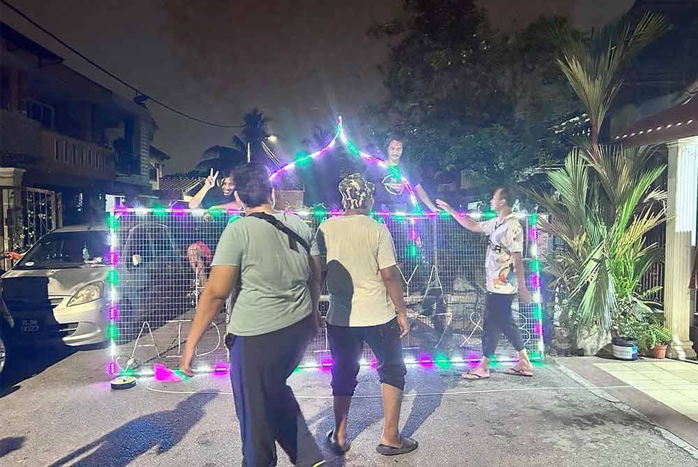 Penduduk di Jalan Sangkar 19/7 dan 7B, Seksyen 19 bergotong-royong menyiapkan hiasan lampu Aidilfitri.