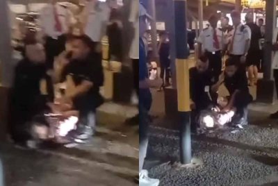 Tangkap layar video tular menunjukkan seorang wanita ditahan apabila didakwa mengekori seorang ibu bersama anak-anaknya serta bertindak agresif, termasuk menendang mangsa.