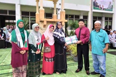 Nik Emran (dua dari kanan) menerima sumbangan al-Quran daripada pengurusan Program World #QuranHour 2025