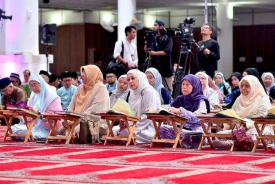 Wan Azizah (dua dari kiri) membaca al-Quran sempena Program World #QuranHour 2025 pada Selasa.