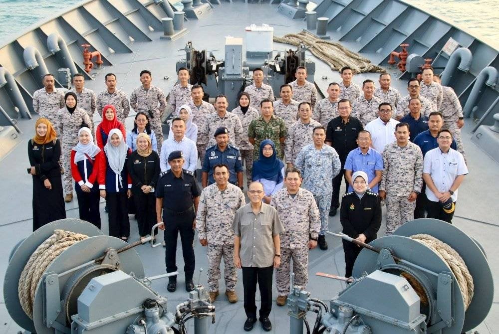 Wan Rosdy bergambar bersama anggota KM Pekan ketika Op Khas Pagar Laut di perairan negeri ini.