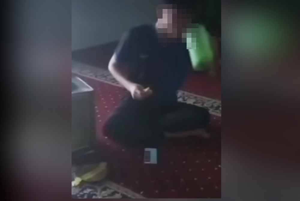 Tangkap layar video remaja yang tidak berpuasa makan di dalam surau.
