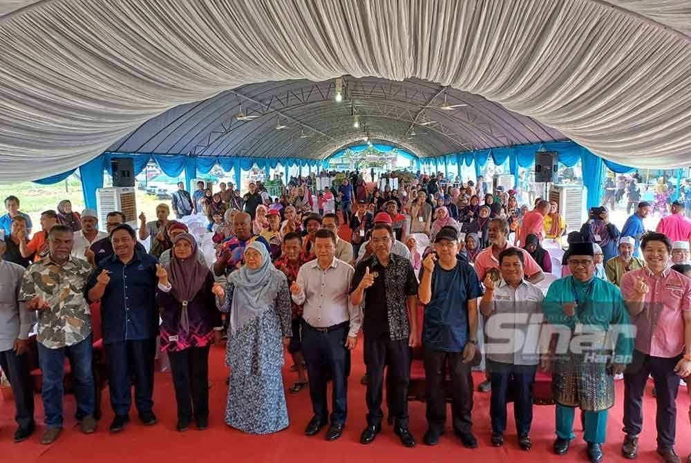 Fuziah (depan, lima dari kiri) bersama penerima bakul makanan ketika program jualan Rahmah Madani mega Aidilfitri di hadapan pasar nelayan Pantai Sepat pada Jumaat. - Foto Sinar Harian