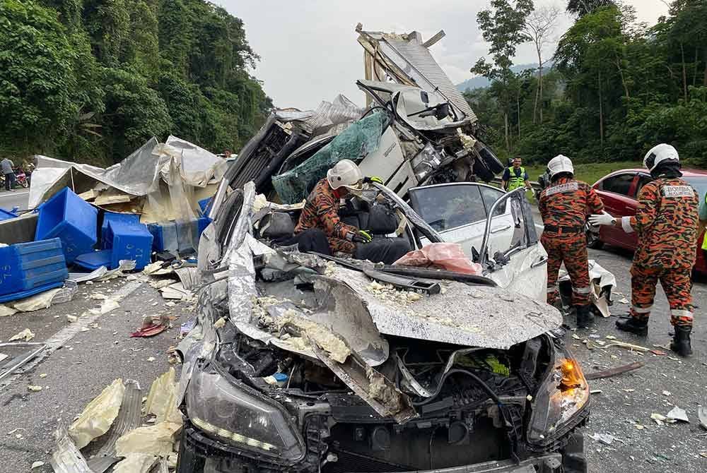 Anggota bomba dari Balai Bomba dan Penyelamat Bentong membantu mengeluarkan mangsa yang tersepit selepas terbabit nahas lima kenderaan di KM50.8 Lebuhraya KL-Karak pada petang Ahad.