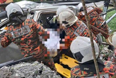 Pasukan bomba mengeluarkan mangsa tersepit dalam pacuan empat roda selepas terbabit dalam kemalangan di Kampung Minangkop, Tamparuli, Tuaran.