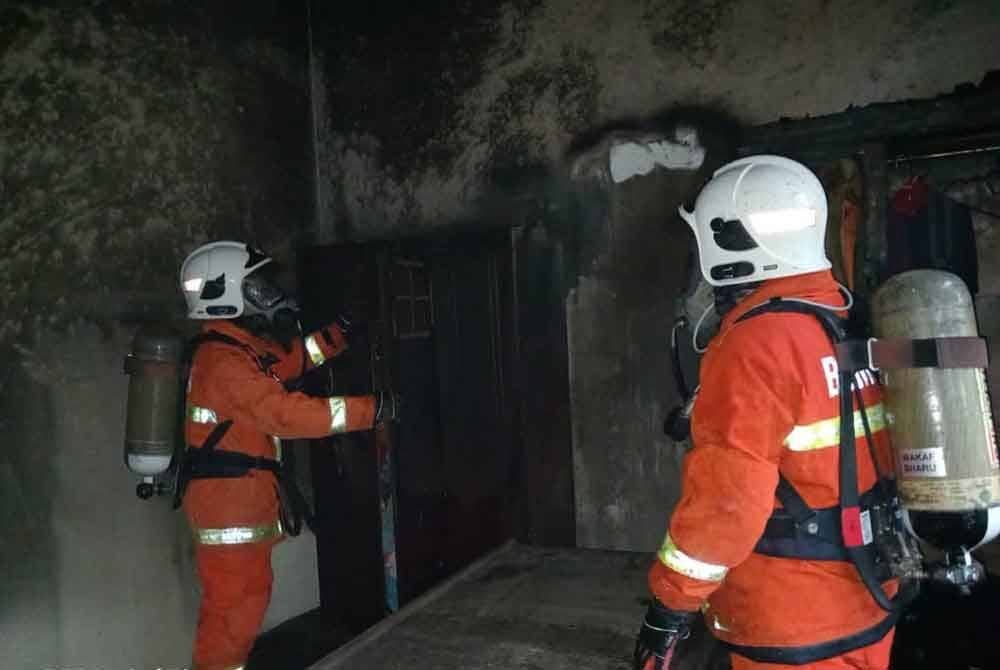 Bomba memeriksa sisa kebakaran sebuah bilik pada pagi Rabu.