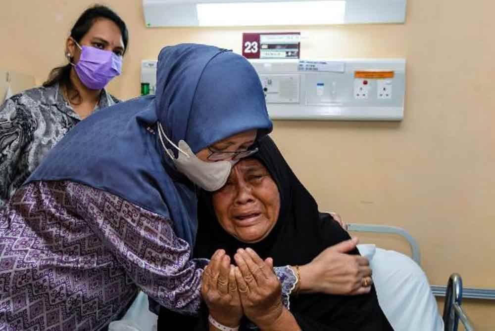Dr Zaliha (kiri) menenangkan mangsa kebakaran saluran gas di Putra Heights, Rokiah Othman, ketika beliau menziarahi mangsa-mangsa dalam kejadian itu yang kini menerima rawatan di Hospital Putrajaya. Foto Bernama