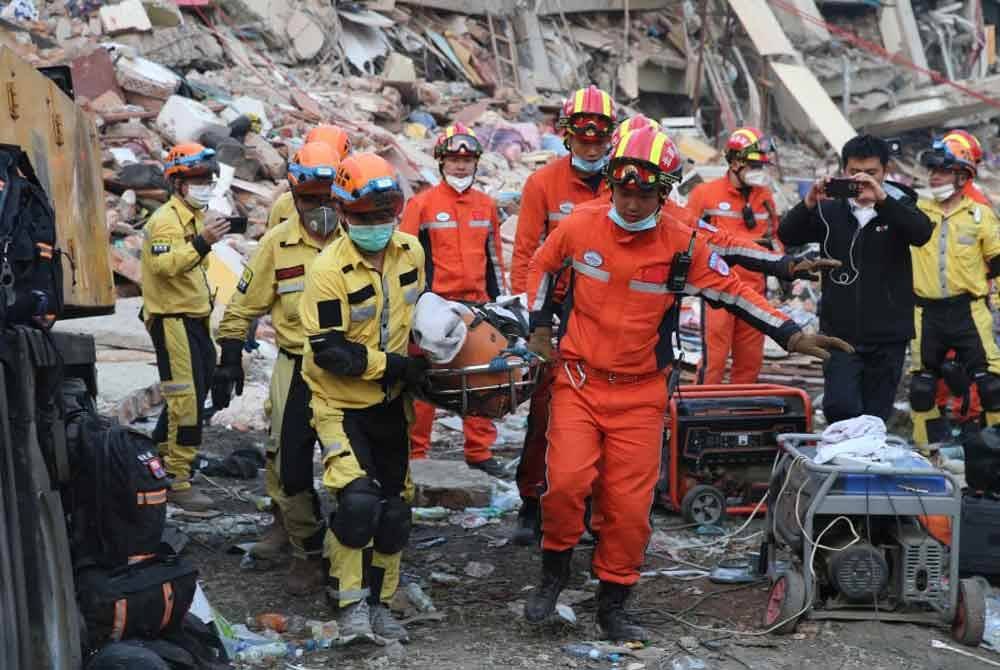 Anggota pasukan mencari dan menyelamat memindahkan mangsa di tapak gempa bumi di bandar Mandalay, Myanmar. Foto Xinhua