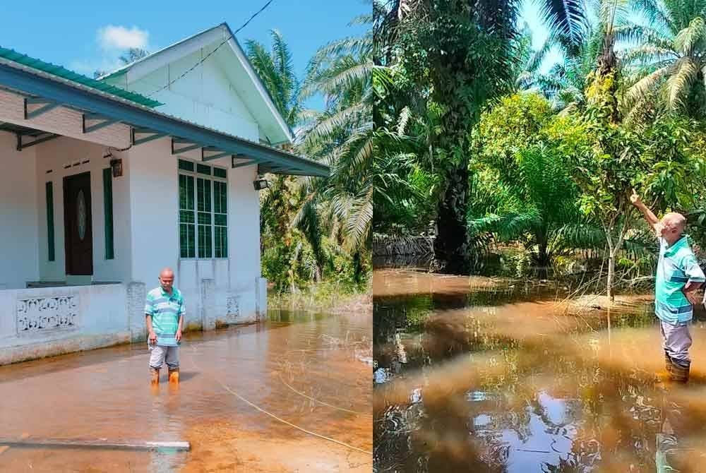 Samsudin di depan rumahnya di Kampung Baru, Batu Pahat yang dilanda banjir termenung.