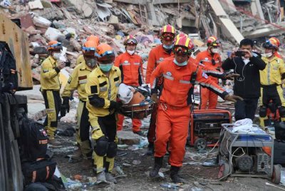Anggota pasukan mencari dan menyelamat memindahkan mangsa di tapak gempa bumi di bandar Mandalay, Myanmar. Foto Xinhua