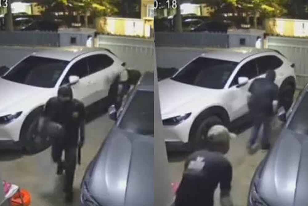 Tangkap layar CCTV memaparkan dua penjenayah bertopeng serta berparang memasuki kawasan rumah di sebuah taman perumahan di Puncak Alam, Sabtu lalu.