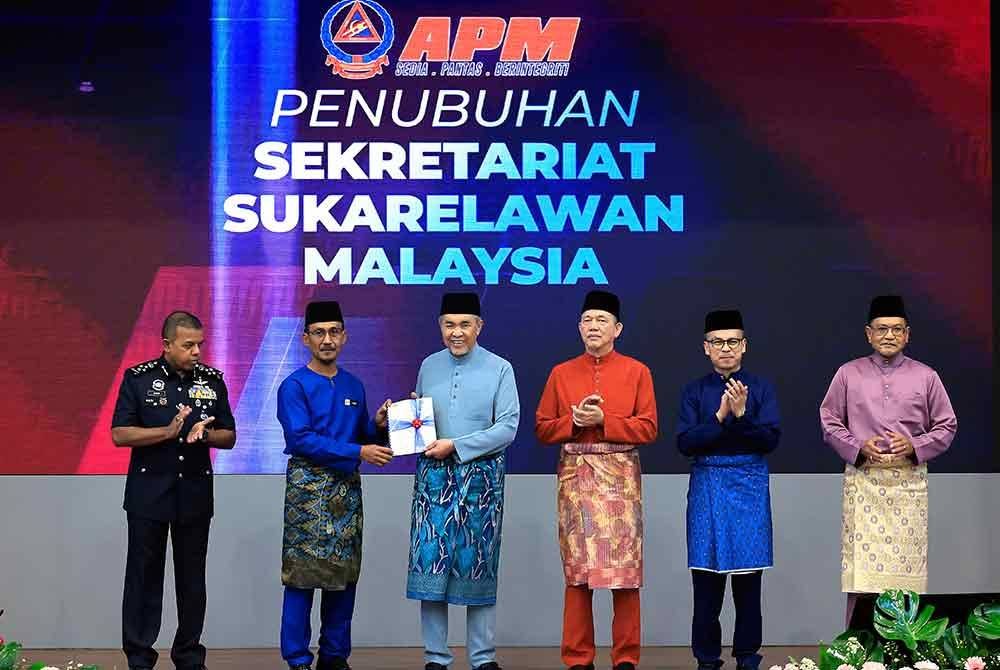 Ahmad Zahid (tiga, kanan) menerima dokumen Penubuhan Sekretariat Sukarelawan Malaysia dari Ketua Pesuruhjaya Angkatan Pertahanan Awam Malaysia (APM), Datuk Roslan ​​​​Wahab (dua, kiri) pada Sambutan Penutup Bulan Pertahanan Awam 2025 di Ibu Pejabat Pertahanan Awam pada Selasa. Turut sama Fadillah (dua, kanan), Fahmi (kanan) dan Timbalan Ketua Polis Negara Datuk Seri Ayob Khan Mydin Pitchay (kiri). Foto Bernama