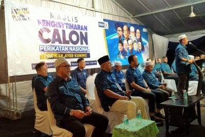 Razman (kiri) hadir meraikan Majlis Pengisytiharan Calon PN pada Selasa.